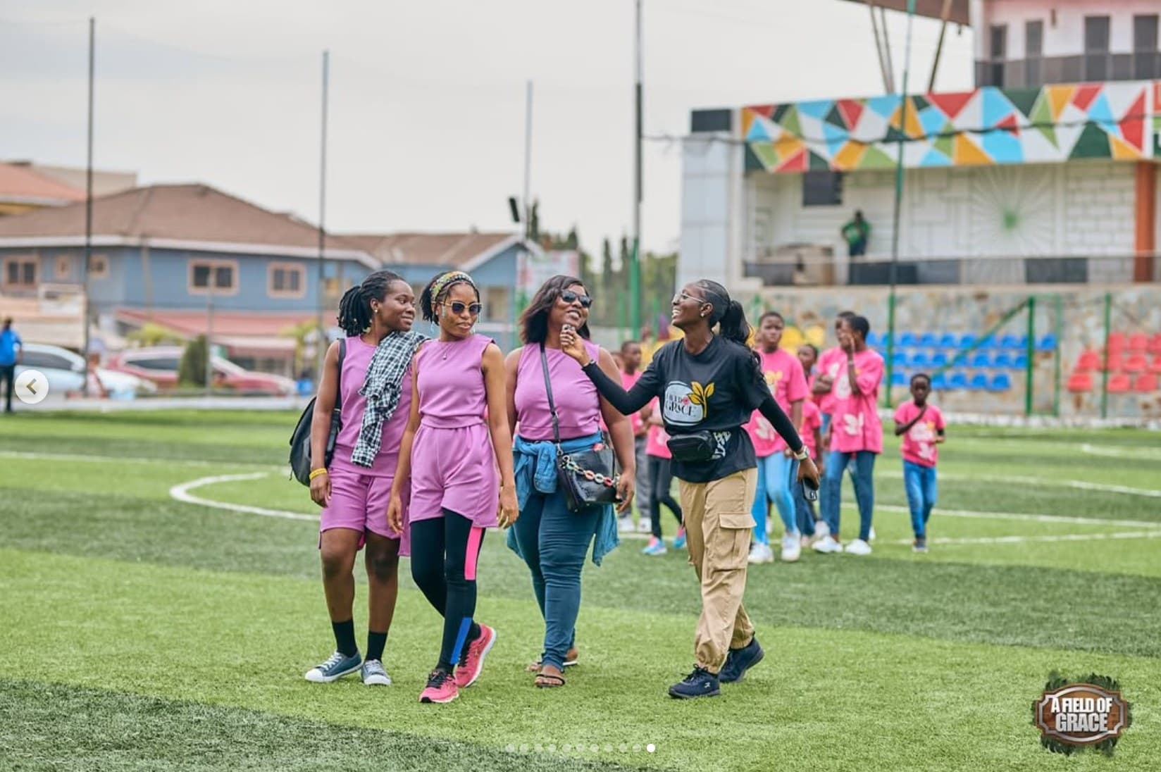 Volunteers and children walking the field together
